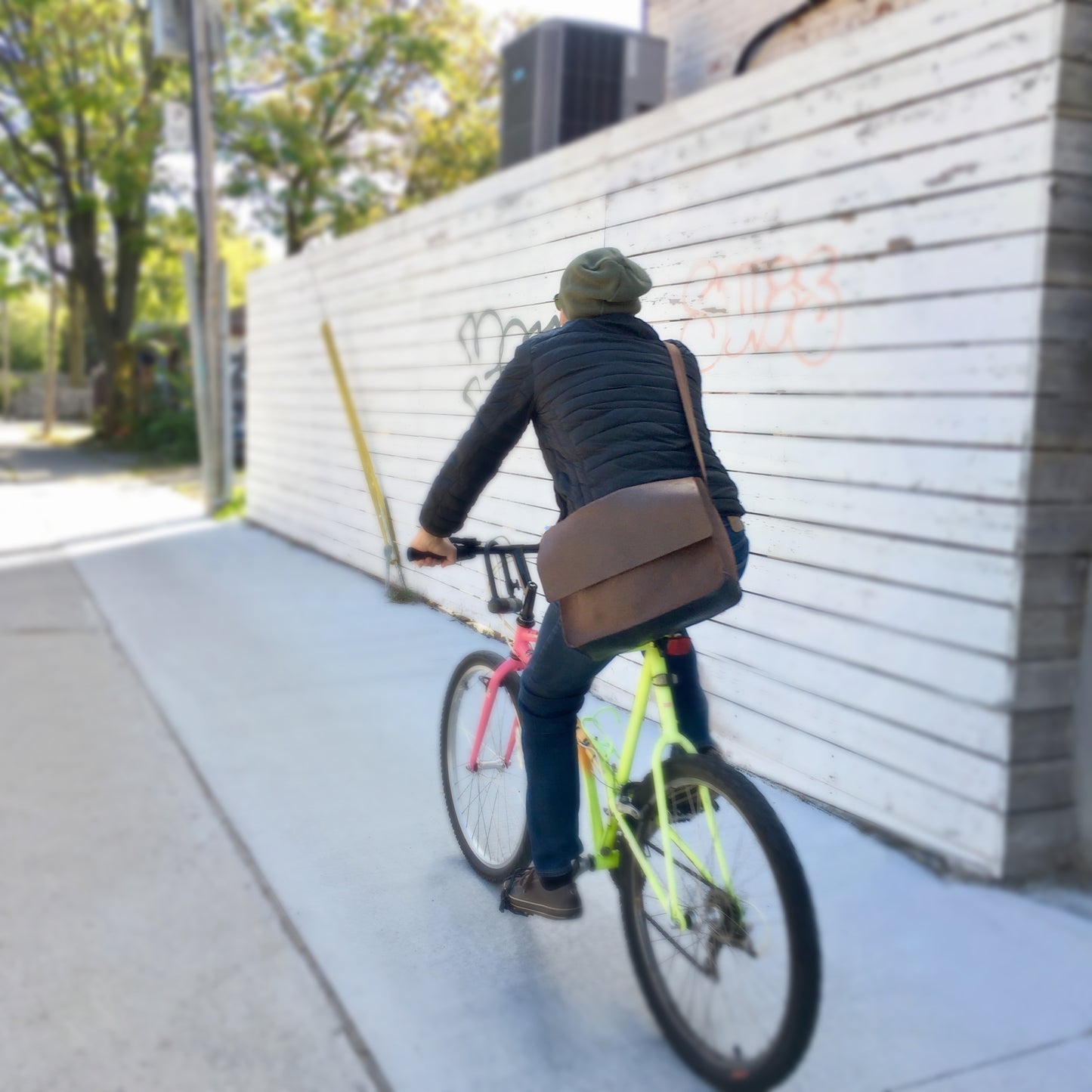 Man holding Miina Gabriel Leather Messenger Bag