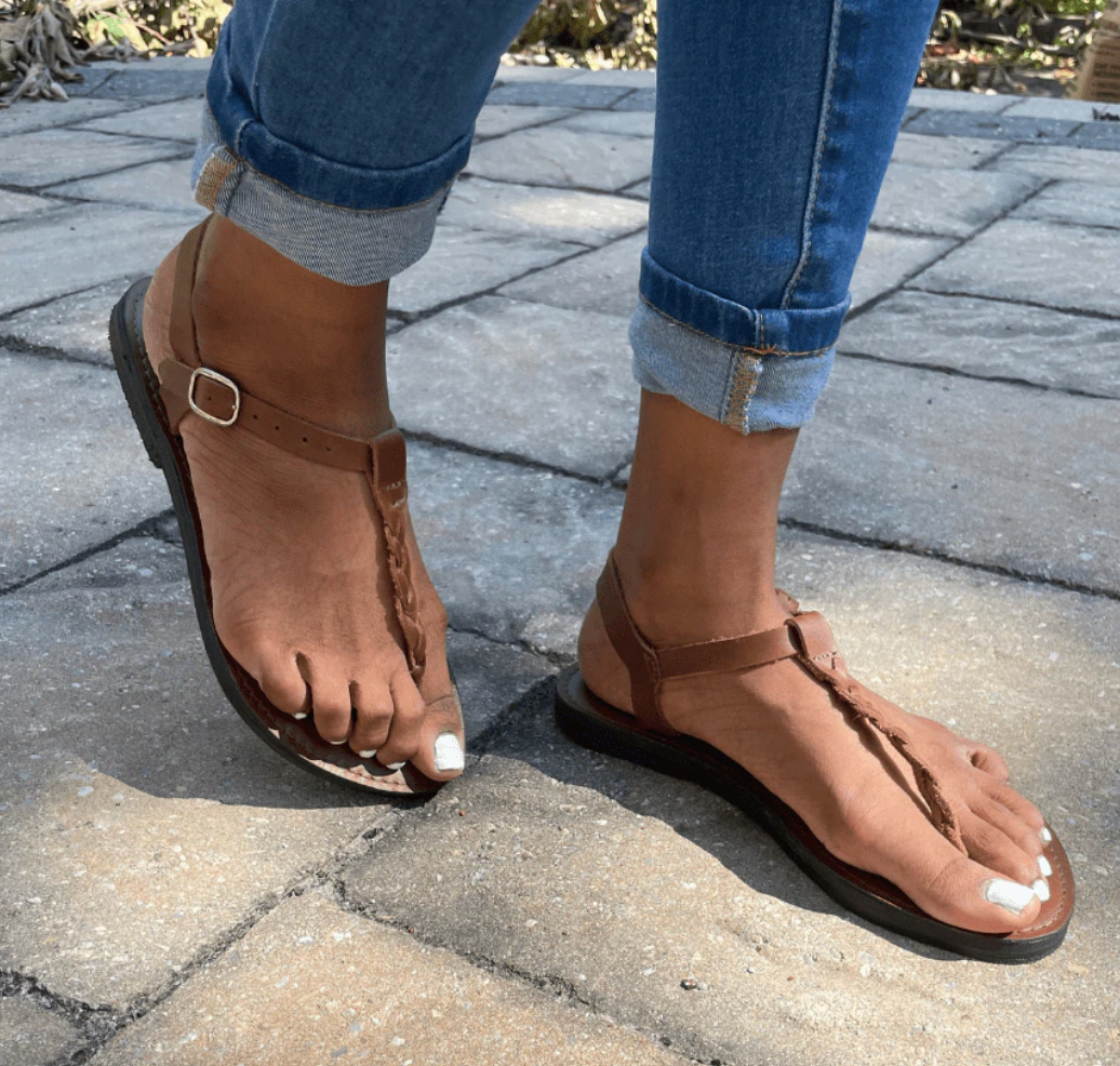 Brave Soles Bonita sandals on model's feet walking on sidewalk