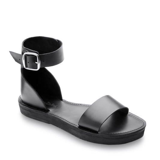 The Miina Black Camila Flatform Sandal: Trendy black leather flatform sandal with a cushy 1" midsole and secure fit, combining style and all-day comfort.