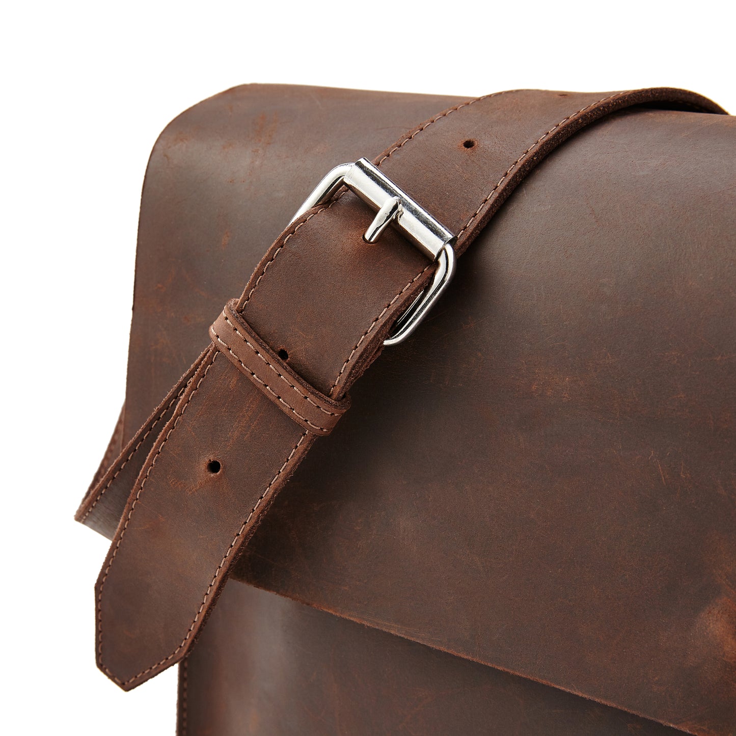 Close-up of the adjustable leather belt strap of the Miina Messenger Bag, highlighting its sturdy craftsmanship and customizable fit.