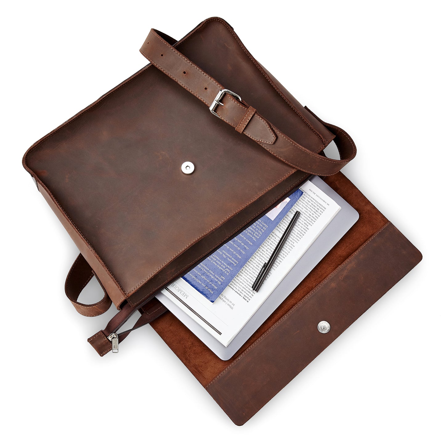 The Miina Leather Messenger Bag laying flat and open, displaying its organized compartments with a laptop, paper, pen, and notebook neatly placed inside.