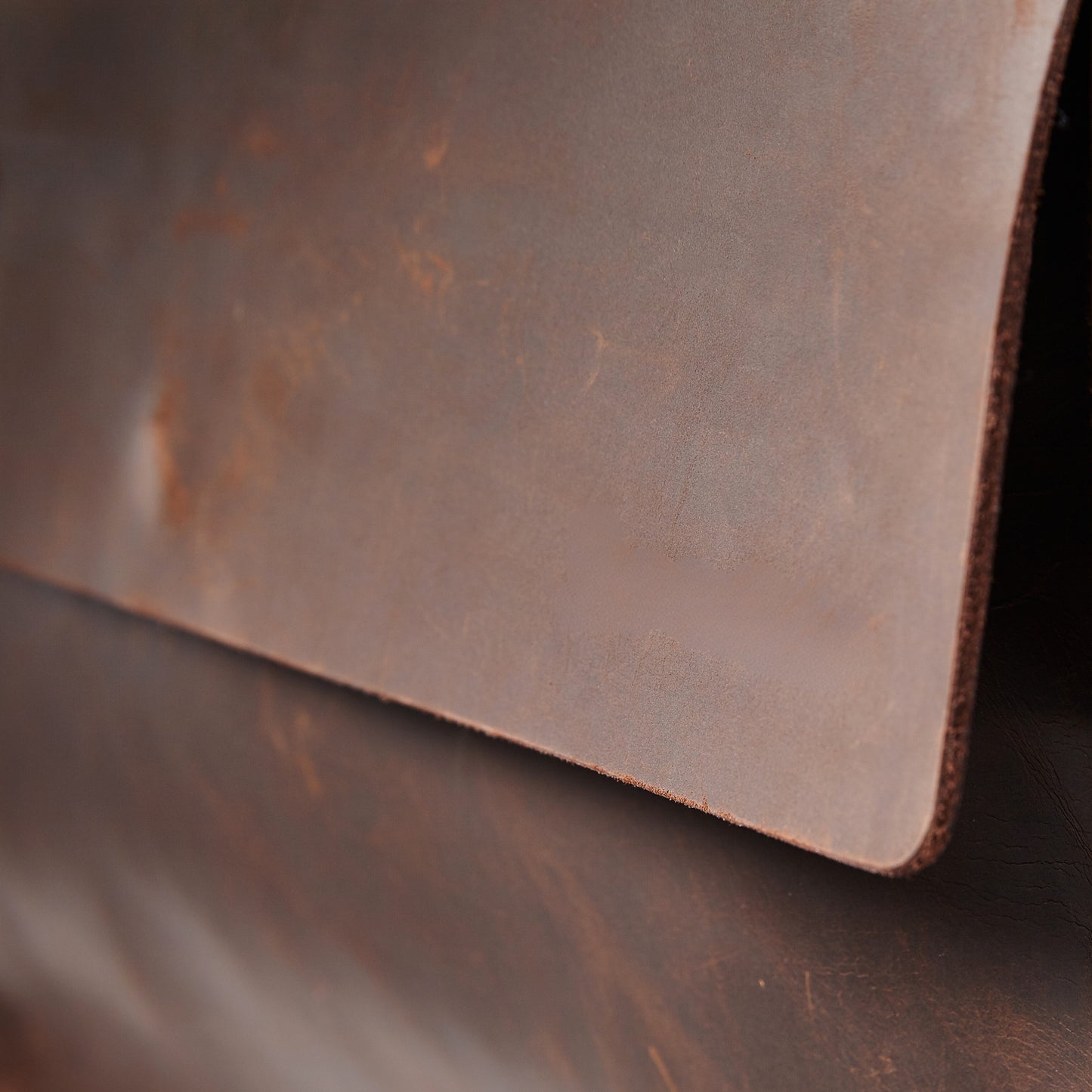 Miina Gabriel leather messenger bag. Close up showing the side of the bag.